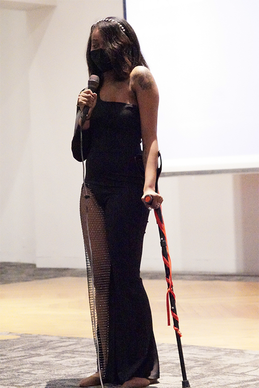 image of Ellice singing on the stage wearing a black dress